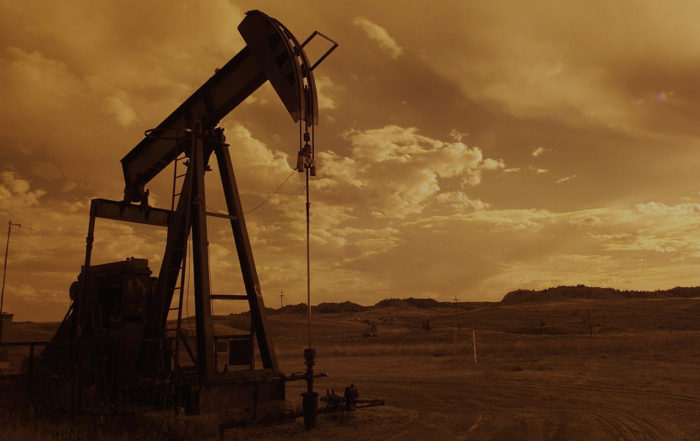 An image showing an oilwell at sunset